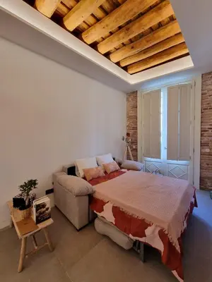 Cama o camas de una habitación en Antiquari de Blanes Apartamento Boutique en la Costa Brava