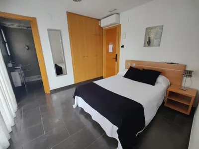 Cama o camas de una habitación en Hostal Manel