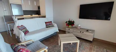 Una televisión o centro de entretenimiento en LLOGUER30 Garbí Love, vistas espectaculares del mar
