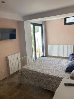 Cama o camas de una habitación en Casa con vista y jardín, a 20' de la playa