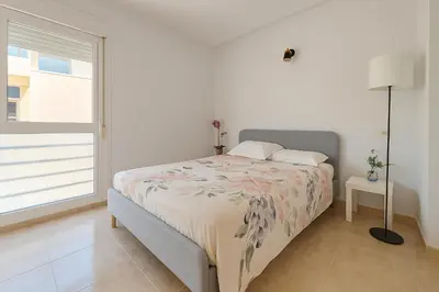 Cama o camas de una habitación en Apartamento moderno junto a la playa Ideal familias
