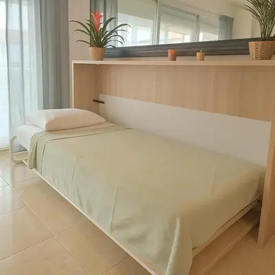 Cama o camas de una habitación en Apartamento moderno junto a la playa Ideal familias