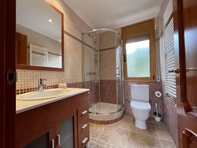 Un baño de Casa Mas Cabañas con piscina infinita con playa