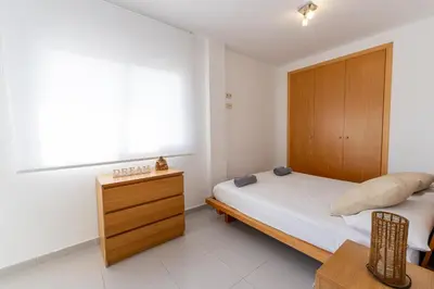 Cama o camas de una habitación en Penthouse Fenals Beach