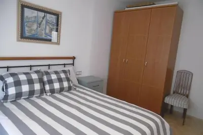 Cama o camas de una habitación en AMPLIO Y CONFORTABLE APARTAMENTO con PARKING