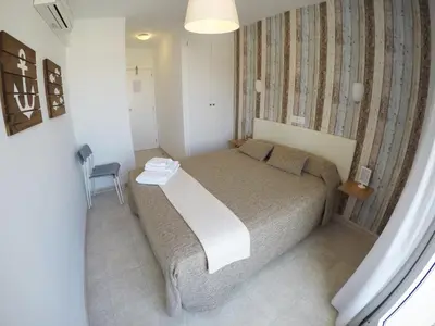 Cama o camas de una habitación en Hostal del Mar