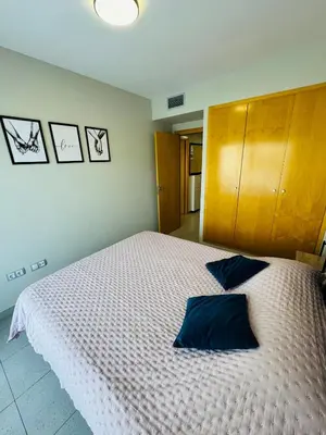 Cama o camas de una habitación en Hermoso piso en un paso de la Playa de Fenals con piscina