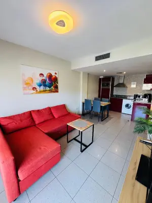 Zona de estar de Hermoso piso en un paso de la Playa de Fenals con piscina