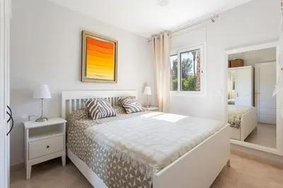 Cama o camas de una habitación en SeaBreezeHeaven - Sea View Apartment, Pool & Spacious Terrace with BBQ - 50m from Sant Pol Beach