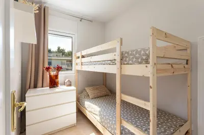 Cama o camas de una habitación en SeaBreezeHeaven - Sea View Apartment, Pool & Spacious Terrace with BBQ - 50m from Sant Pol Beach