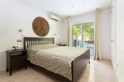 Cama o camas de una habitación en SeaBreezeHeaven - Sea View Apartment, Pool & Spacious Terrace with BBQ - 50m from Sant Pol Beach