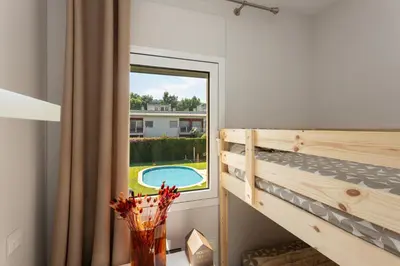 Cama o camas de una habitación en SeaBreezeHeaven - Sea View Apartment, Pool & Spacious Terrace with BBQ - 50m from Sant Pol Beach