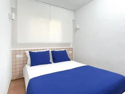 Cama o camas de una habitación en Parc Golfet - Apartamento para 3 con WiFi, AC y Piscina