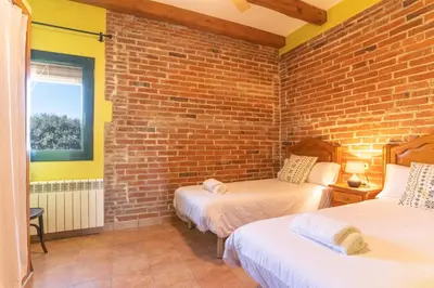 Cama o camas de una habitación en Can Pujol - Casa Rural 16-20 personas