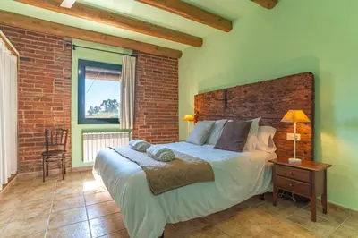 Cama o camas de una habitación en Can Pujol - Casa Rural 16-20 personas