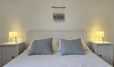 Cama o camas de una habitación en Bright Apartment with Two Balconies and a Seaside Pool