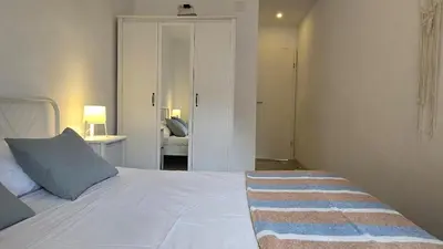 Cama o camas de una habitación en Bright Apartment with Two Balconies and a Seaside Pool