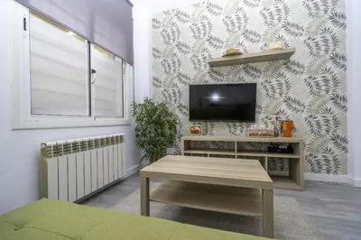 Una televisión o centro de entretenimiento en HomeHolidaysRentals Balmes - Costa Barcelona