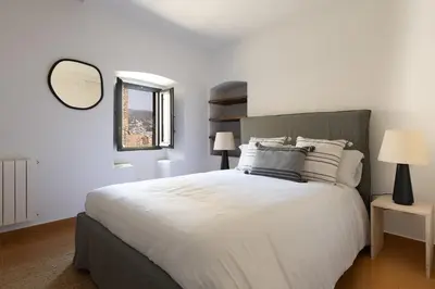 Cama o camas de una habitación en LETS HOLIDAYS Stay in a 14th-Century House with Pool in Tossa