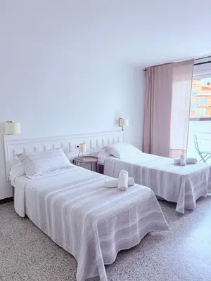 Cama o camas de una habitación en L'Illa Hotel