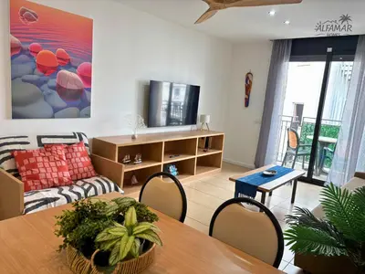 Una televisión o centro de entretenimiento en Bali Suite - Modern Apartment with Parking & Swimming Pool