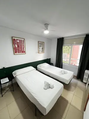 Cama o camas de una habitación en Hostal Blanc Lloret