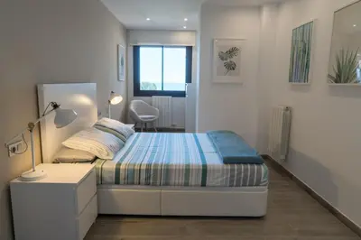 Cama o camas de una habitación en SeaHomes Vacations - Cala Banys Seafront Apt & PKG