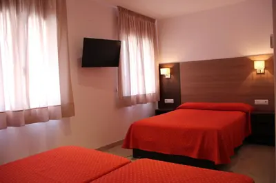 Cama o camas de una habitación en Hotel Victoria