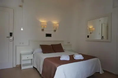 Cama o camas de una habitación en Hotel Hermes