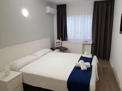 Cama o camas de una habitación en Hotel Victoria