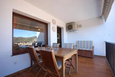 Una televisión o centro de entretenimiento en LETS HOLIDAYS Sea views apartment pool in Sa Gabarra