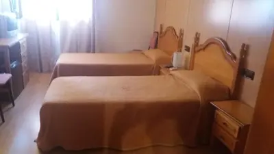 Cama o camas de una habitación en Hostal Bonaterra