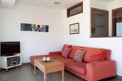 Una televisión o centro de entretenimiento en Lets Holidays AMAZING TRIPLEX SEA VIEWS in TOSSA