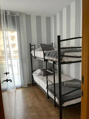Cama o camas de una habitación en Apartamentos Jardín Turquesa