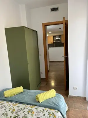 Cama o camas de una habitación en Apartamentos Jardín Turquesa