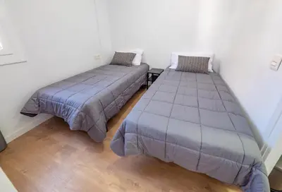 Cama o camas de una habitación en Apartamentos AR Melrose Place