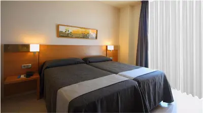 Cama o camas de una habitación en AQUA Hotel Nostre Mar Apartments