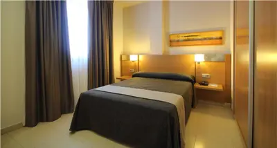 Cama o camas de una habitación en AQUA Hotel Nostre Mar Apartments