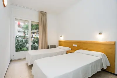 Cama o camas de una habitación en Apartamentos Blanes-Condal Costa Brava
