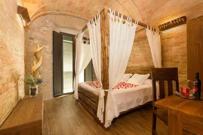 Cama o camas de una habitación en Hotel Històric