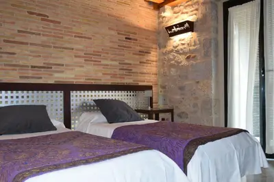 Cama o camas de una habitación en Hotel Històric