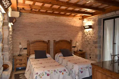 Cama o camas de una habitación en Hotel Històric