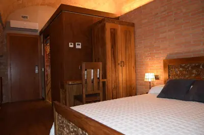 Cama o camas de una habitación en Hotel Històric