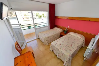 Cama o camas de una habitación en Hostal Magnolia