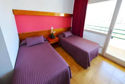 Cama o camas de una habitación en Hostal Magnolia