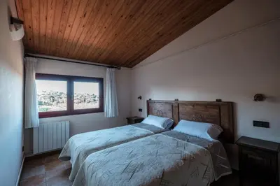 Cama o camas de una habitación en Apartamentos Rurales Els Masos d'en Coll