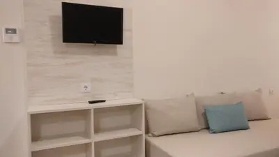 Una televisión o centro de entretenimiento en Aparthotel Las Mariposas