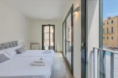 Cama o camas de una habitación en Flateli Pou Rodó 1
