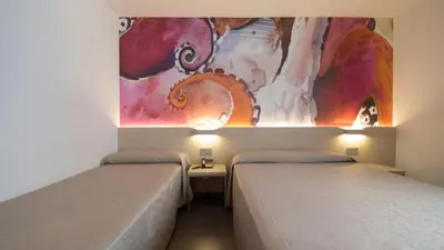 Cama o camas de una habitación en Hotel Riviera