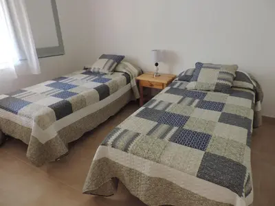 Cama o camas de una habitación en Apartamentos Les Palmeres